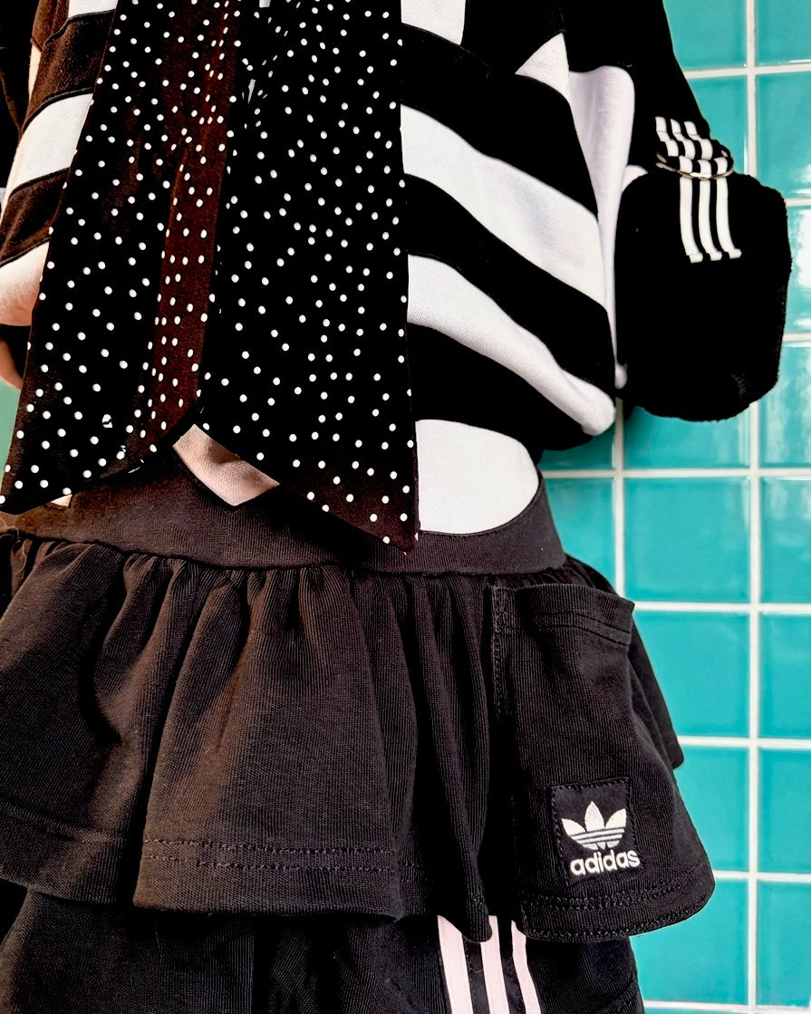 Mono Adidas hoodie and layered skirt.