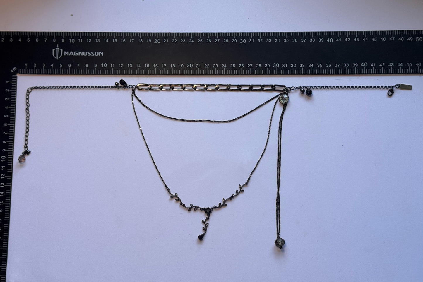 Black multi chain drop necklace with gems